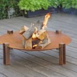 Alna rusting steel wood burning fire pit on the patio
